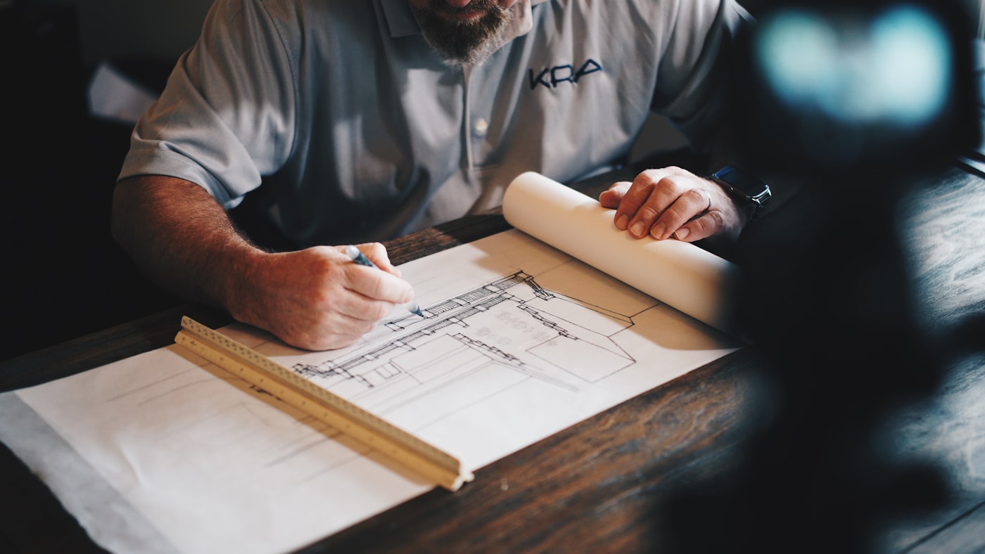 Architect drawing site plans on a working table